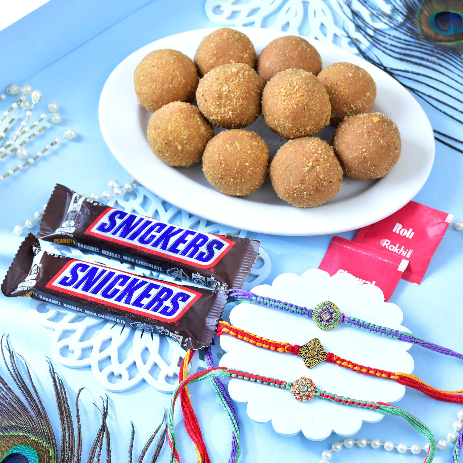 Set Of Three Traditional Rakhi With Besan Laddu & Snickers Chocolates