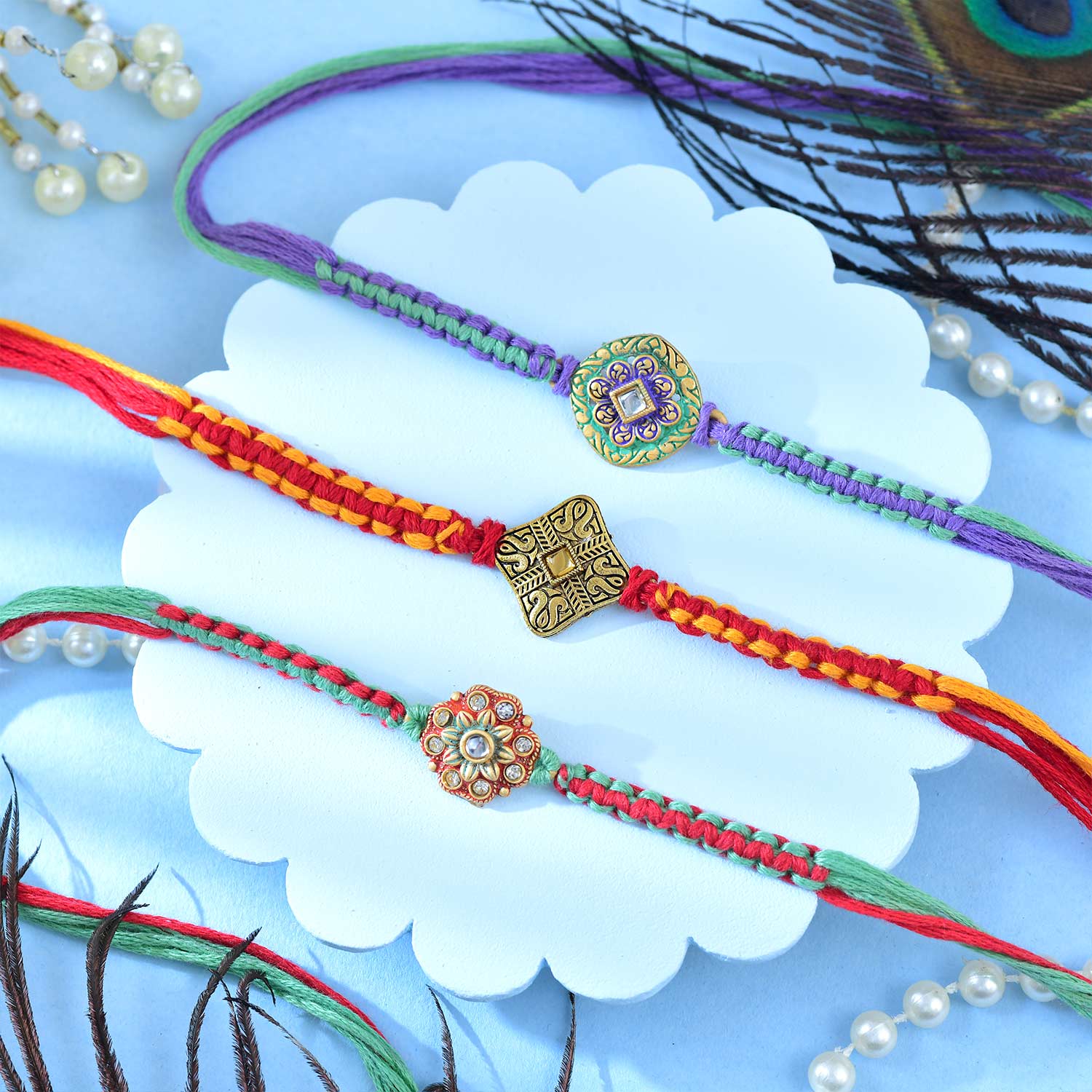 Set Of Three Traditional Rakhi With Besan Laddu & Snickers Chocolates