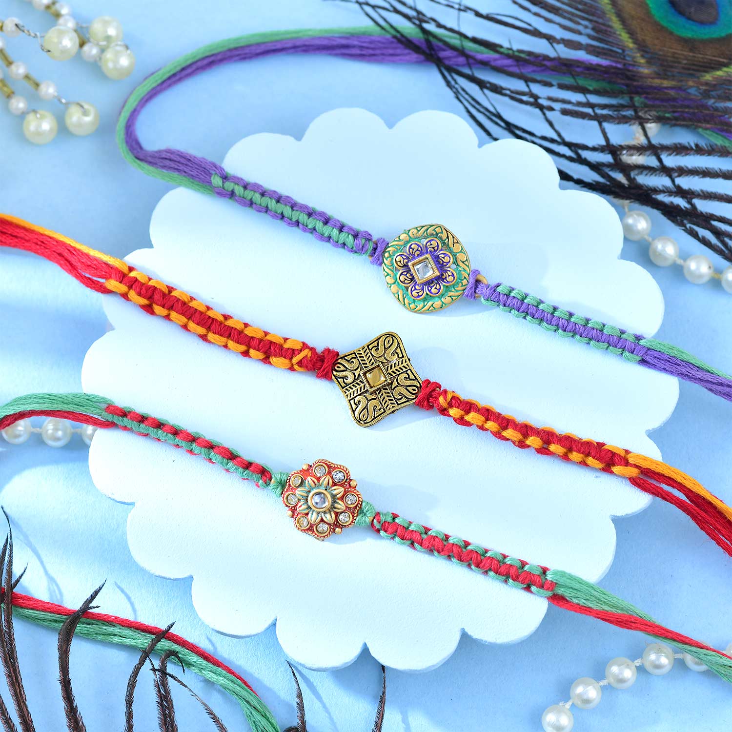 Set Of Three Traditional Rakhi With Besan Laddu & Toblerone Chocolates