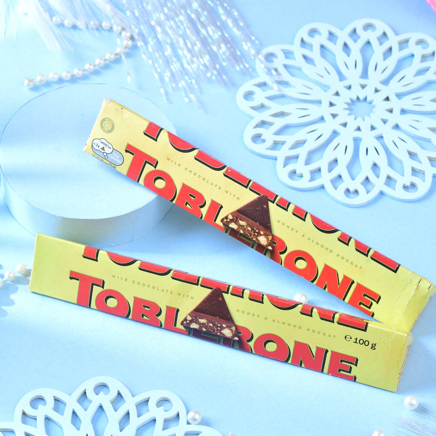 Set Of Three Traditional Rakhi With Besan Laddu & Toblerone Chocolates